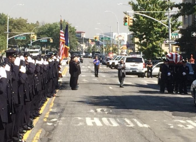 Officers in salute paying respect to Ret. Chief Benjamin Foster at Funeral.